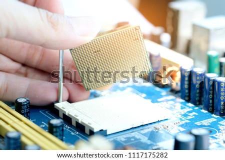 Hand of computer engineering brings computer cpu processor memory change components into socket processor for maintenance.Technology and development concept
