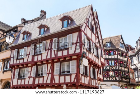 View on street in Colmar, Alsace, France, with beautiful decorations on facade.
