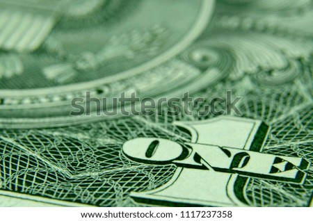 Close up, negative space, background shot of 1 and 'ONE' on the American one dollar bill.