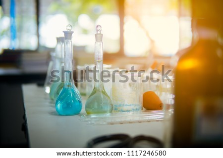 Soft glassware chemistry for test in laboratory classroom on blurred student learning in lab. Happy science students group for study about substance and experiment. 