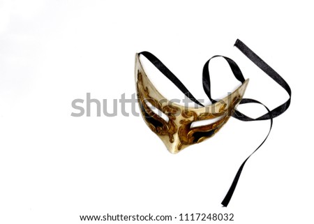 Beige-gold Venetian mask with black satin lace on a white background to hold your text