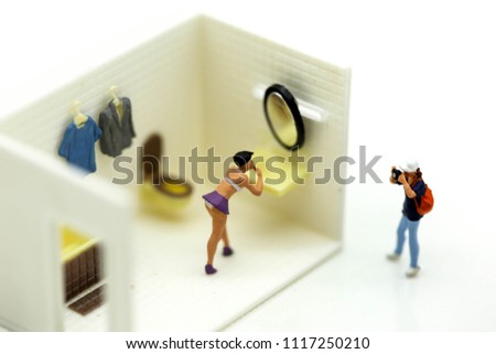 Miniature people : man is hiding behind  bathroom Spying. Voyeurism with woman  taking shower