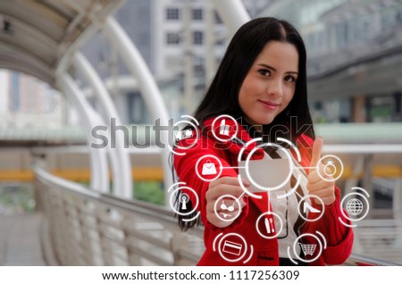 beautiful young woman in red jacket holding credit card and showing thumbs up with graphic icon diagram, internet, fashion, promotion, special offer, winter sale, payment and shopping online concept