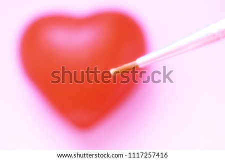 Blurry image,The brush is painted on a red heart, the background symbolizes life and love,need blur picture