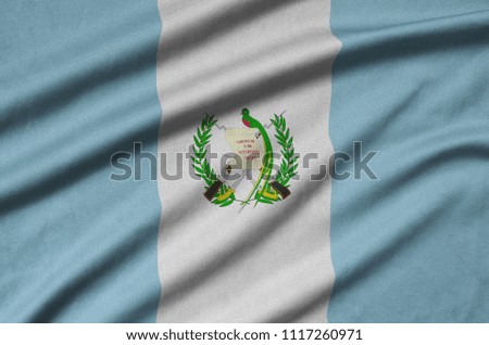 Guatemala flag  is depicted on a sports cloth fabric with many folds. Sport team banner