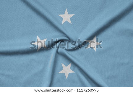 Micronesia flag  is depicted on a sports cloth fabric with many folds. Sport team banner