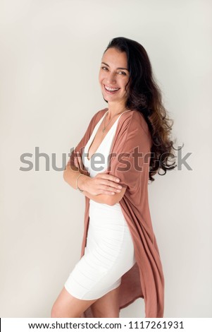 Brunette woman standing and laughing Royalty-Free Stock Photo #1117261931