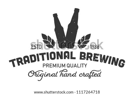 Vintage traditional brewing monochrome logo with beer bottles, inscriptions and wheat ears isolated vector illustration