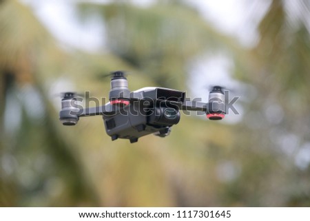 A portable drone flying in open space