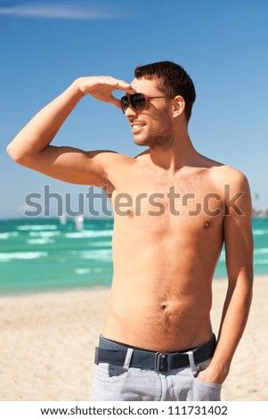 bright picture of happy smiling man on the beach.