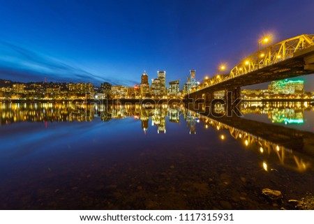 Portland Oregon city downtown skyline by Hawthorne Bridge during evening blue hour