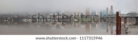 A foggy day in Portland Oregon city downtown waterfront marina along Willamette River panorama