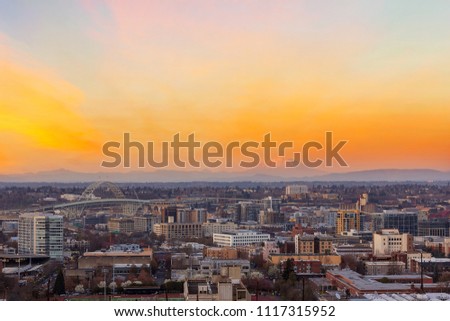 Portland Oregon downtown cityscape with Mt Saint Helens view during sunset at dusk