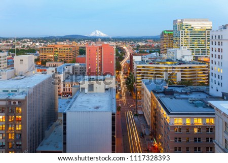 Portland Oregon downtown cityscape with Mount Hood view along street to Morrison Bridge with light trails