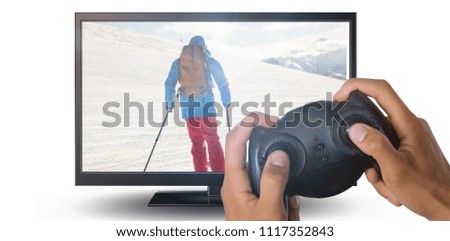 Cropped image of hands holding controller against close-up of blank computer monitor