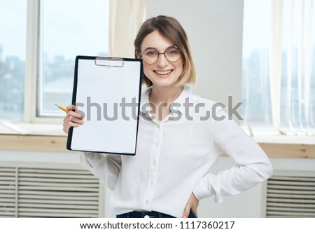 happy woman holding a folder with a sheet of paper                             