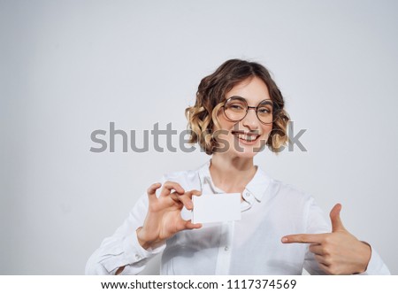   woman smiling with glasses points a finger at the place free                             