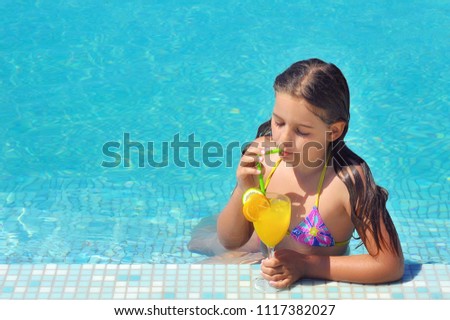 Real adorable girl relaxing in swimming pool, summer vacation concept