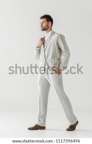 serious young man in vintage stylish suit on white