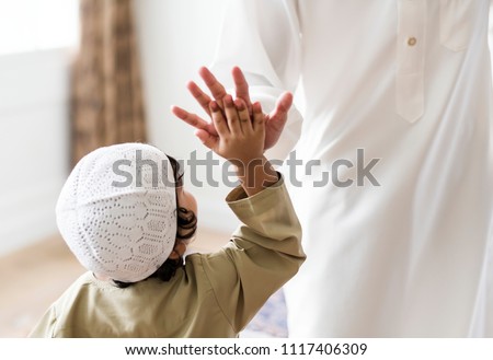 Muslim boy giving a high five Royalty-Free Stock Photo #1117406309