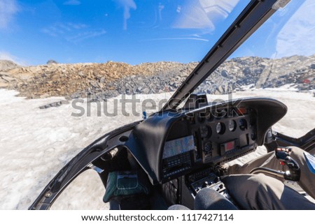 View from of cockpit of a helicopter as it flies over the Fox Glacier in South island New Zealand