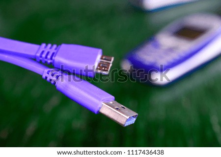 new usb 3 purple cable with old phone on the background  