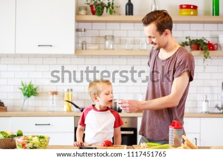 Image of father with son cooking vegetables