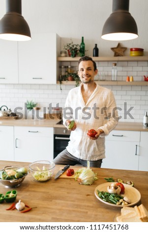 Picture of brunet cooking vegetables on table