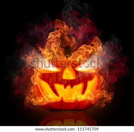 Burning halloween pumpkin, isolated on black background