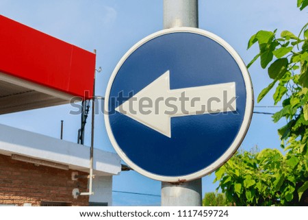 blue round road sign obligation to turn left in Spain