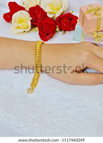 Graceful golden bracelet isolated on woman hand