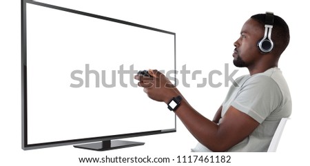 Man playing video game against white background against blank computer monitor