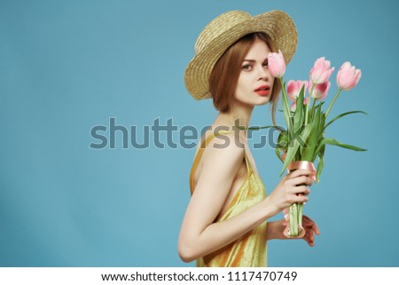 woman with hat and pink flowers                            
