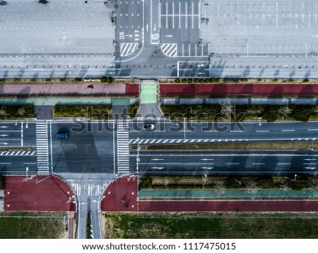 Aerial shooting of vast parking lots and national highways.