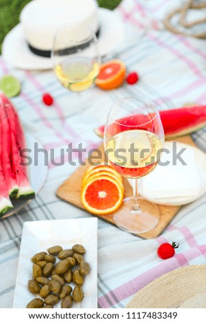 Picnic background with white wine on green grass close-up