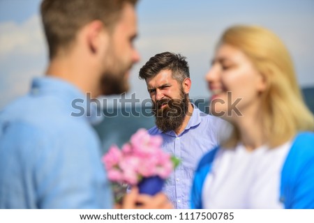 Couple in love happy dating, jealous bearded man watching wife cheating him with lover. Lovers meeting outdoor flirt romance relations. Jealous concept. Couple romantic date lovers bouquet flowers. Royalty-Free Stock Photo #1117500785