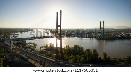 Aerial view of Alex Fraser Bridge during a vibrant sunny day. Taken in North Delta, Greater Vancouver, BC, Canada.