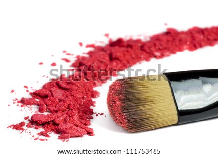 Professional make-up brush on red crushed eyeshadow