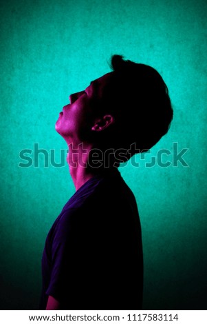 Silhouette of a man deep in thought. A side view of a person who is seriously concerned.
