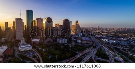 Massive city along gulf coast Houston Texas sunrise aerial drone view golden hour ring around horizon y’all skyscrapers downtown skyline cityscape with traffic and highways with a high flood risk