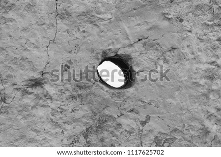 hole in concrete black and white photo
