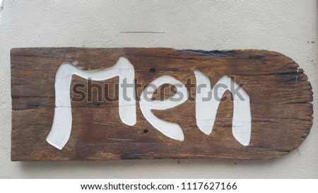 Men toilet sign on wooden board