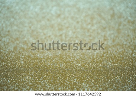 Golden color abstract glitter texture background for anniversary, New Year Eve, Christmas, falling coins, wedding or birthday               