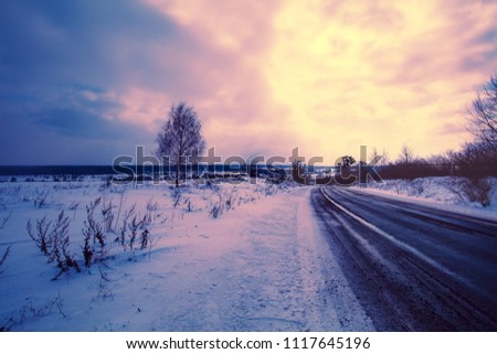 Dramatic winter sunset over road 