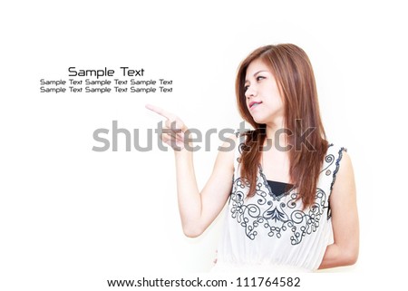 Young Asian woman pointing on white background