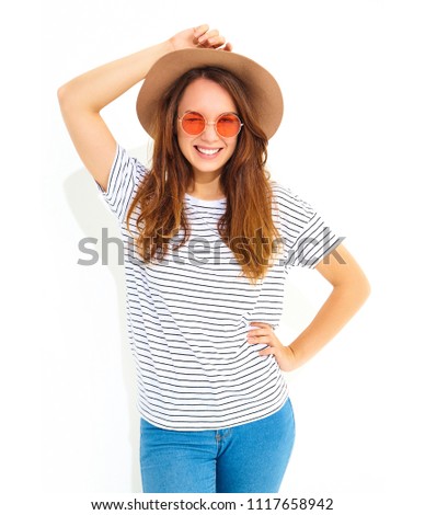 Portrait of young stylish laughing girl model in casual summer clothes in brown hat with natural makeup isolated on white background. Winking