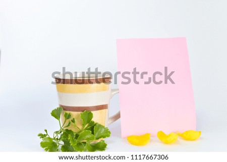A mug and tropical leaves isolated on white background. Empty copy space for text. selective focus.
