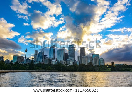 Amazing sunset over the Sydney central business district city skyline seen across the harbor 