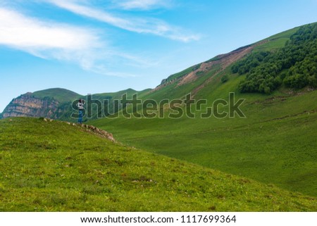 Photographer on a green hill