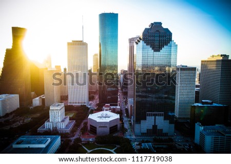 Sun beams shine bright Houston Texas sunrise aerial drone view golden hour ring around horizon y’all skyscrapers downtown skyline cityscape with traffic and highways